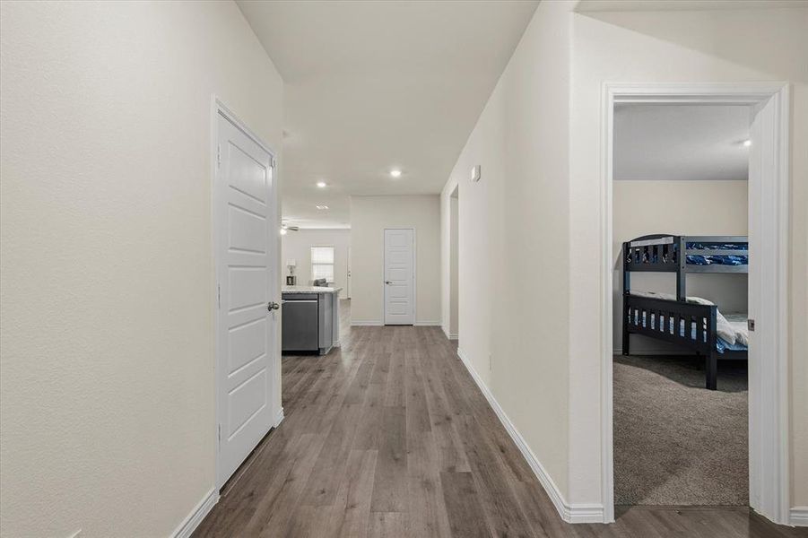 Hallway with dark wood-style flooring and recessed lighting Hallway with dark wood-style flooring and recessed lighting