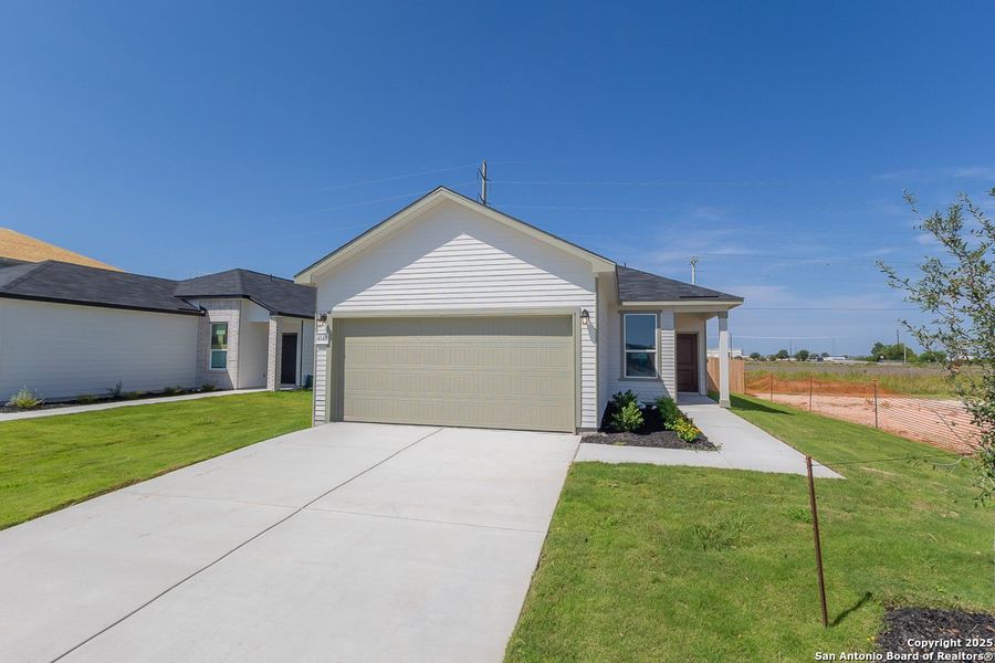 Front exterior of a new home in Woodside Farms, Seguin, TX, highlighting curb appeal (Image 1). Front exterior of a new home in Woodside Farms, Seguin, TX, highlighting curb appeal (Image 1).