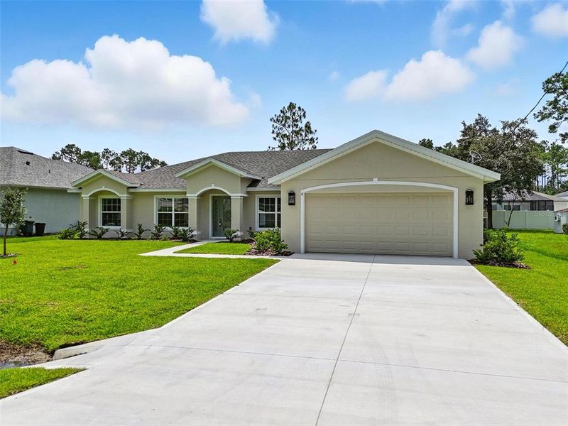 Front exterior of a new home in , Palm Coast, FL, highlighting curb appeal (Image 24).