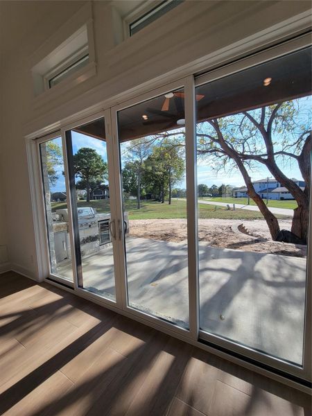 Bright sunroom with large sliding glass doors leading to a patio, offering scenic views of trees and a spacious yard. Perfect for indoor-outdoor living. Bright sunroom with large sliding glass doors leading to a patio, offering scenic views of trees and a spacious yard. Perfect for indoor-outdoor living.