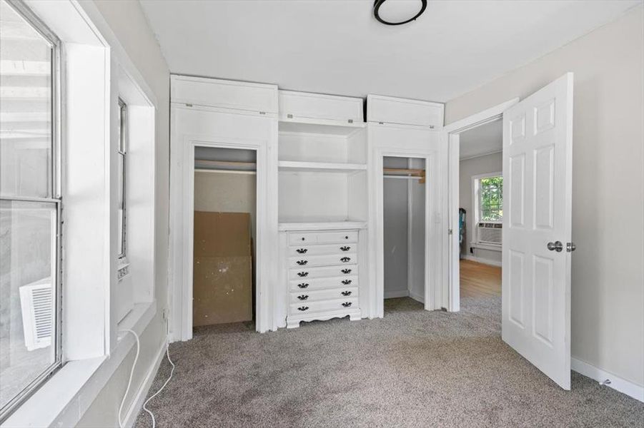 Unfurnished bedroom with carpet flooring Unfurnished bedroom with carpet flooring