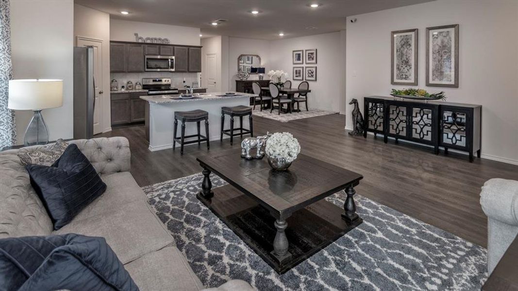 Living room with dark wood-style floors and recessed lighting