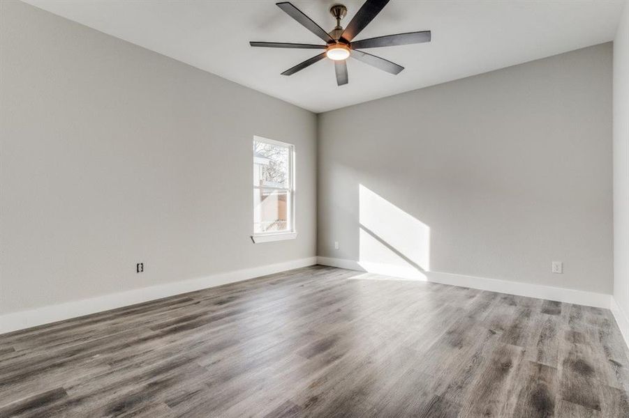 Unfurnished room with ceiling fan and hardwood / wood-style floors