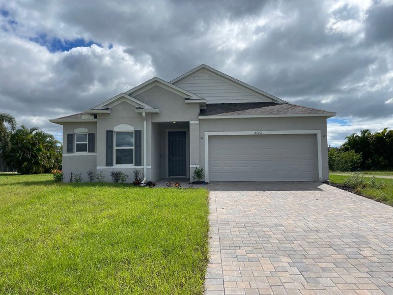 Front exterior of a new home in Cape Coral, Cape Coral, FL, highlighting curb appeal (Image 6). Front exterior of a new home in Cape Coral, Cape Coral, FL, highlighting curb appeal (Image 6).