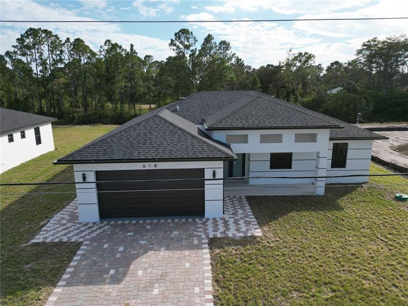 Front exterior of a new home in , Lehigh Acres, FL, highlighting curb appeal (Image 26). Front exterior of a new home in , Lehigh Acres, FL, highlighting curb appeal (Image 26).