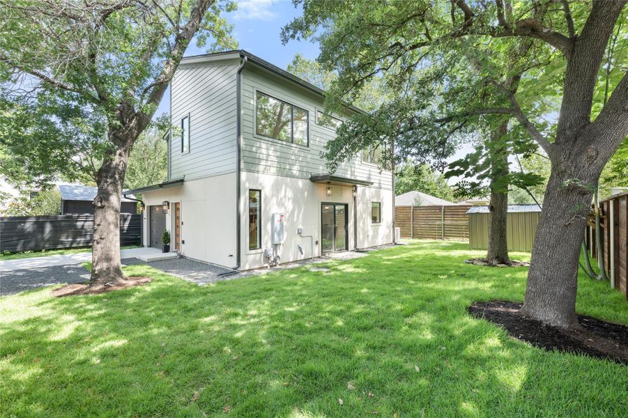 A private, verdant lawn provides a serene backyard escape, framed by a modern home with clean lines. A private, verdant lawn provides a serene backyard escape, framed by a modern home with clean lines.