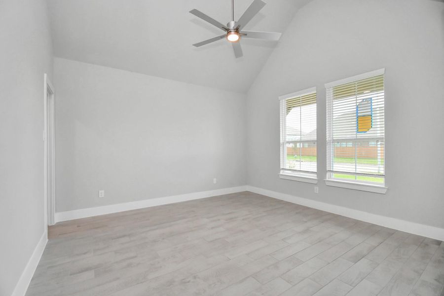 Another view of the spacious office adorned with large windows for natural light. Sample photo of completed home with similar floor plan. Actual colors and selections may vary.