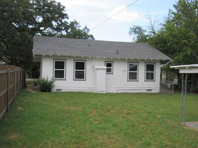 Rear view of property featuring crawl space and roof with shingles Rear view of property featuring crawl space and roof with shingles