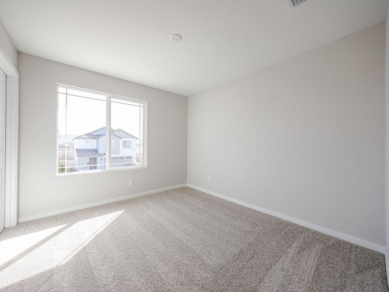 A room with a carpet and a window. A room with a carpet and a window.