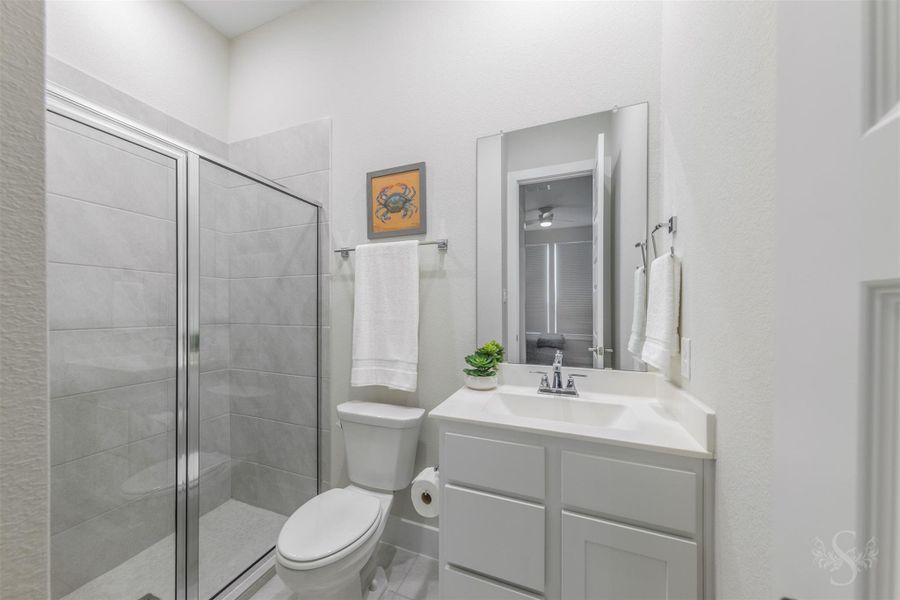 En-suite bath elevates the downstairs guest accommodations with a stylish vanity and beautifully tiled walk-in shower. En-suite bath elevates the downstairs guest accommodations with a stylish vanity and beautifully tiled walk-in shower.