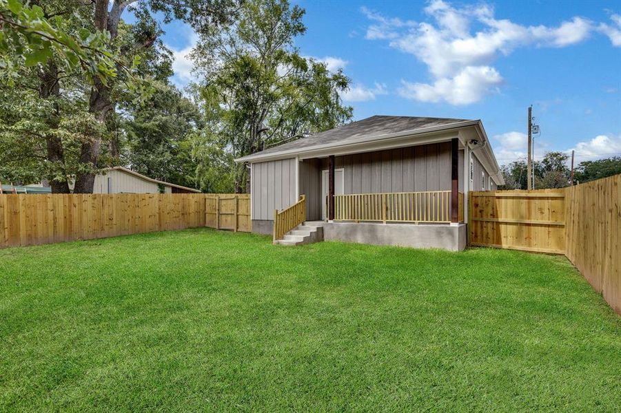 Rear view of house featuring a fenced backyard, board and batten siding, and a shingled roof Rear view of house featuring a fenced backyard, board and batten siding, and a shingled roof