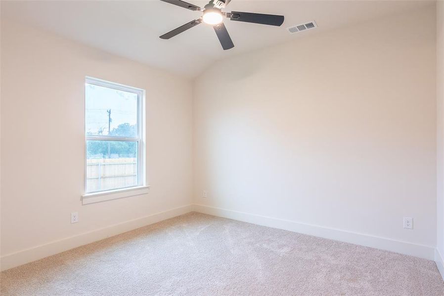 Unfurnished room with carpet, lofted ceiling, and ceiling fan