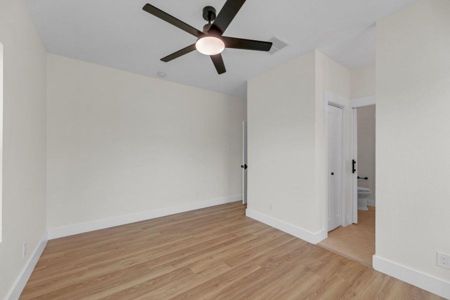 Spare room with light wood-type flooring and a ceiling fan