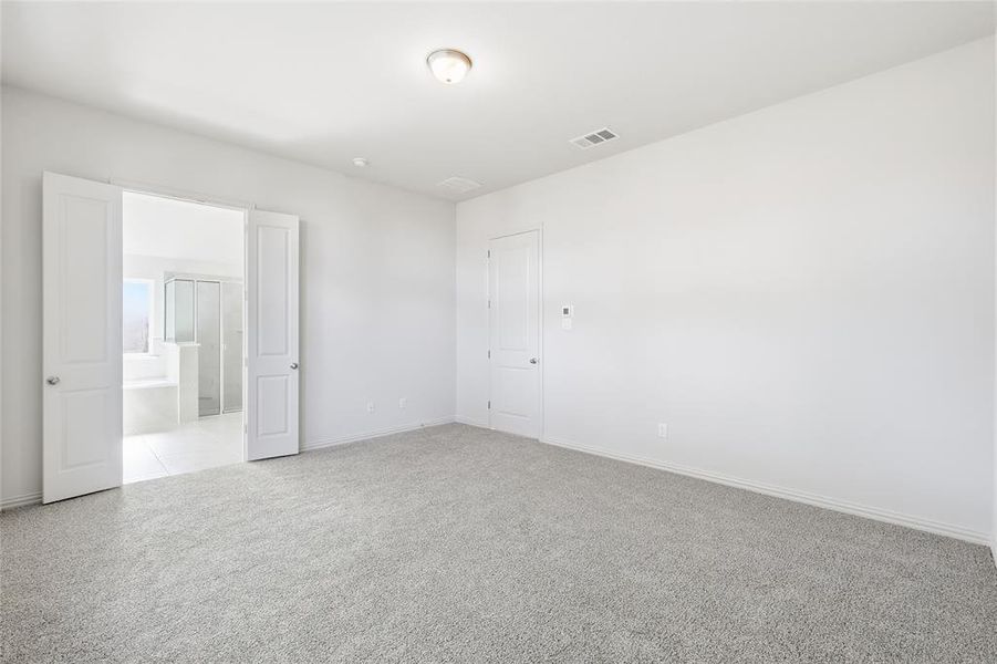Empty room with light carpet and baseboards