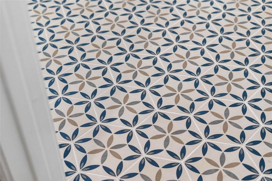 The laundry room tile serves as a stylish and highly functional foundation for a modern laundry room.