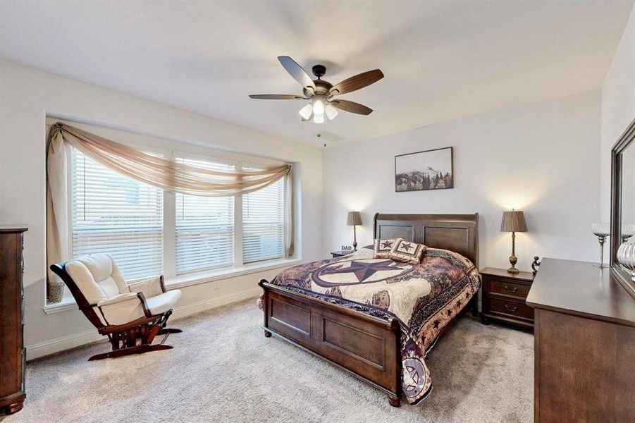 Bedroom featuring light colored carpet and ceiling fan