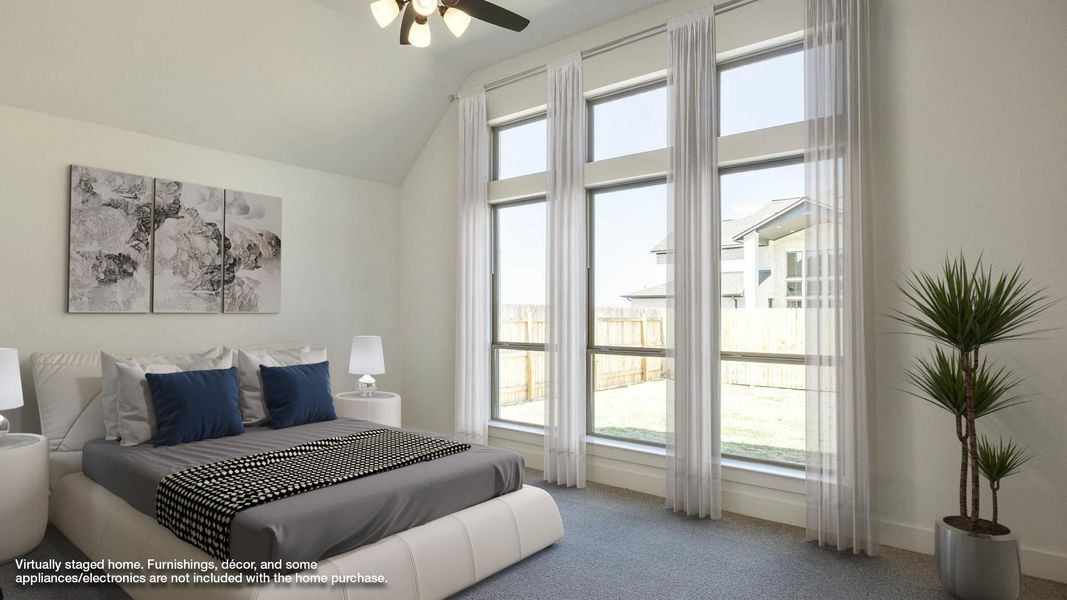 Carpeted bedroom featuring vaulted ceiling and ceiling fan Carpeted bedroom featuring vaulted ceiling and ceiling fan