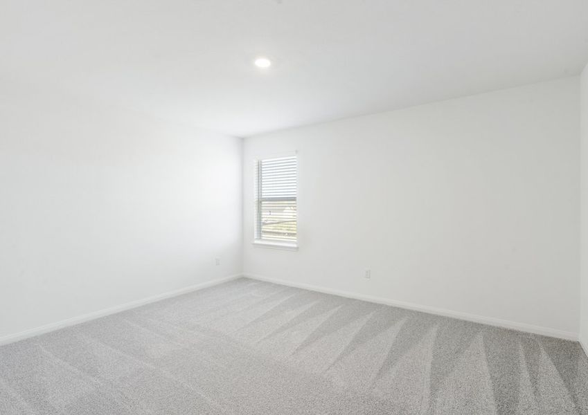 Secondary bedroom with carpet flooring