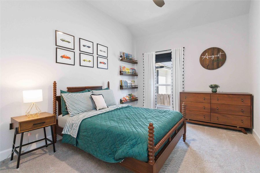 Bedroom featuring light carpet and ceiling fan Bedroom featuring light carpet and ceiling fan