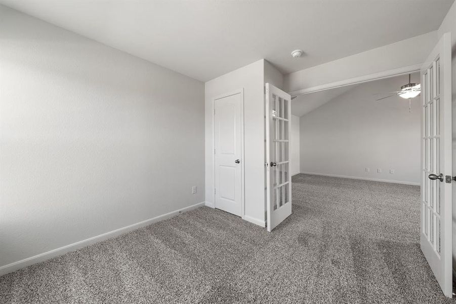 Unfurnished bedroom featuring french doors, carpet floors, and ceiling fan