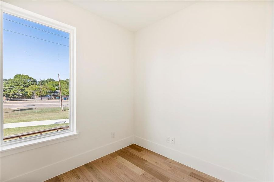 Unfurnished room featuring wood-type flooring