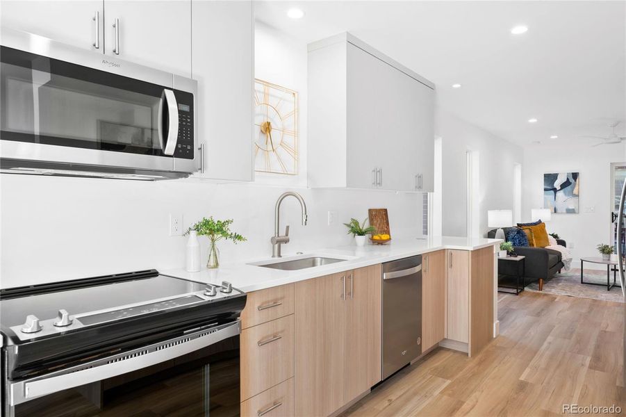 Sleek cabinetry and stainless appliances highlight this bright, modern kitchen.