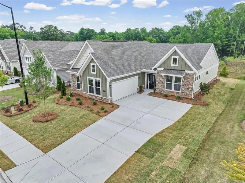Front exterior of a new home in Laurel Farms, Dallas, GA, highlighting curb appeal (Image 18). Front exterior of a new home in Laurel Farms, Dallas, GA, highlighting curb appeal (Image 18).