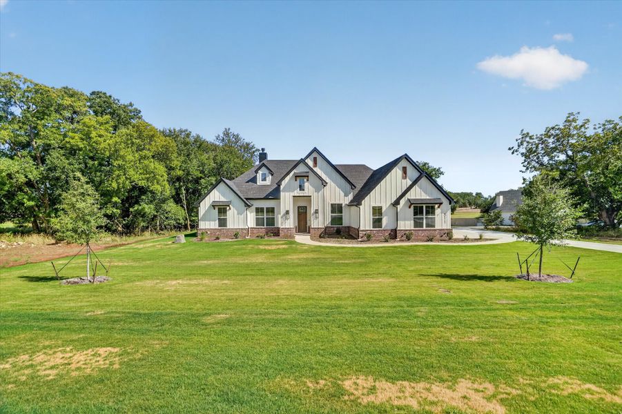 Front exterior of a new home in Cartwright Ranch, Weatherford, TX, highlighting curb appeal (Image 22). Front exterior of a new home in Cartwright Ranch, Weatherford, TX, highlighting curb appeal (Image 22).