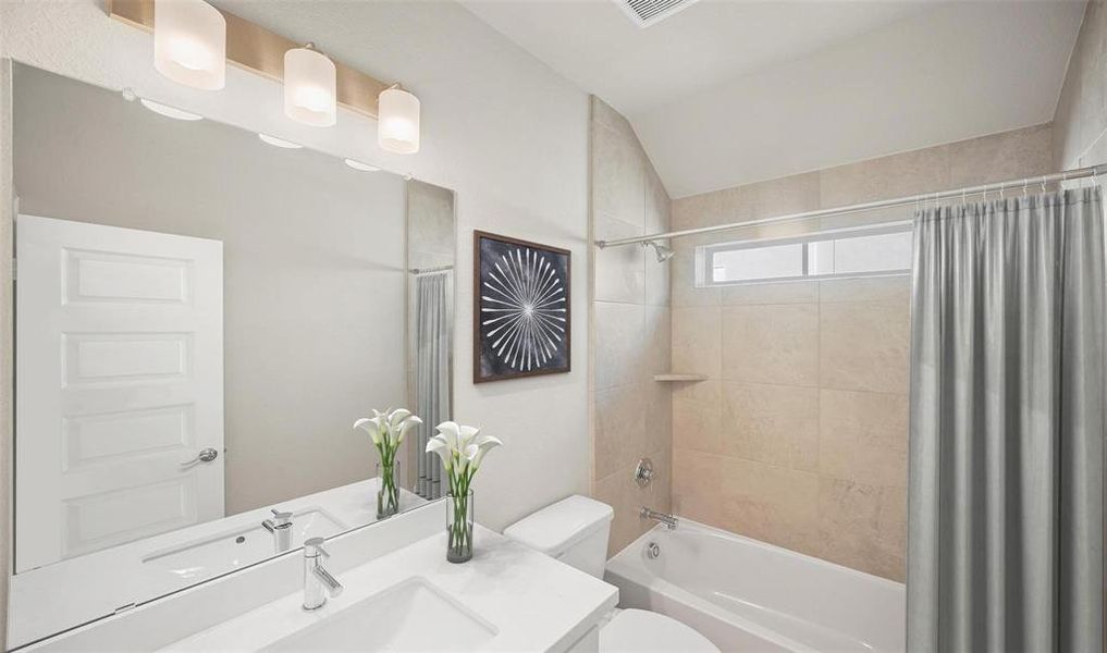 This secondary bathroom features quartz countertops and new tub.