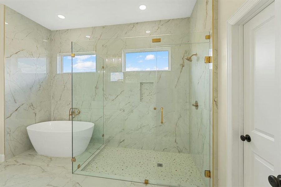 Bathroom with plenty of natural light, a marble finish shower, marble tiled flooring, a soaking tub, and recessed lighting