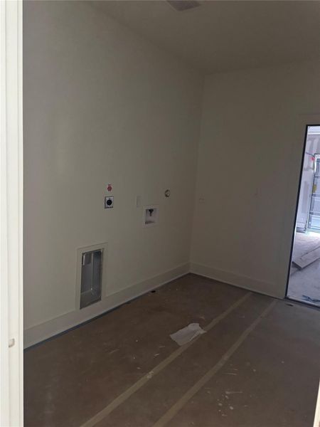 Washroom with hookup for an electric dryer and hookup for a washing machine