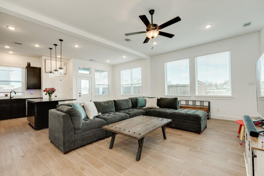 As you enter the front door, you are greeted by an open floor plan, seamlessly connecting the family room, kitchen, and dining area. The stairs are conveniently located on your left.