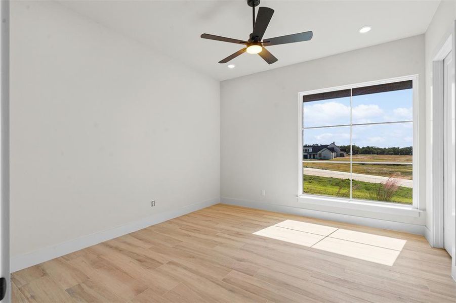 Unfurnished room featuring light wood-style floors, a ceiling fan, and recessed lighting Unfurnished room featuring light wood-style floors, a ceiling fan, and recessed lighting