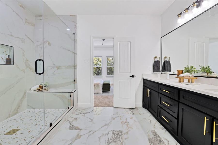 Bathroom featuring a shower with door and vanity