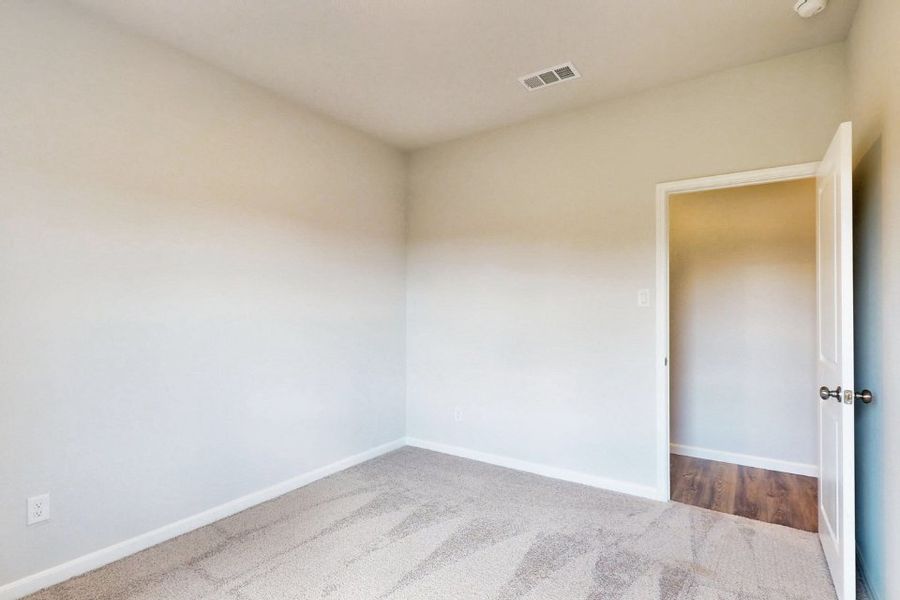 A room with a carpet and a door. A room with a carpet and a door.