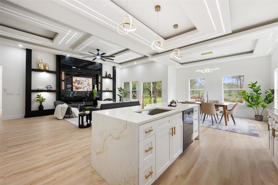 Gourmet kitchen island featuring a waterfall countertop with integrated sink and dishwasher