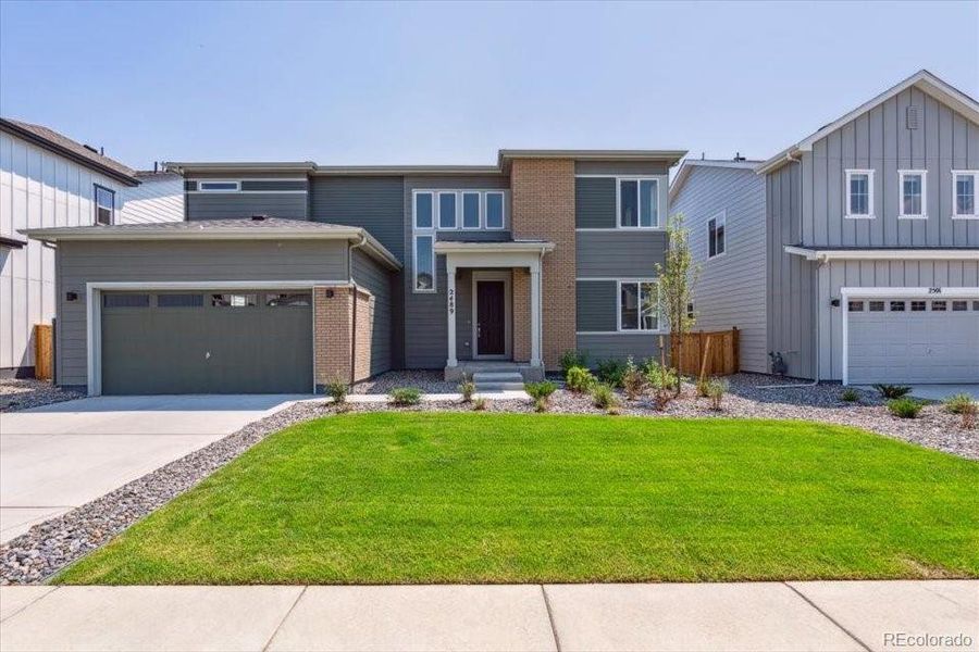 Front exterior of a new home in Prestige Collection at Parkdale Commons, Lafayette, CO, highlighting curb appeal (Image 1).