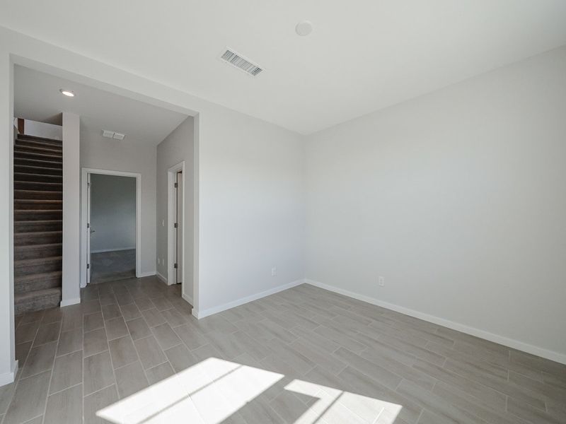 A room with a wood floor and a tile floor.