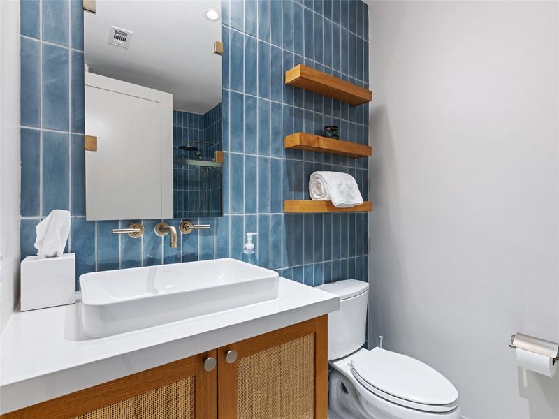 Modern vanity with a rectangular vessel sink, white countertop, and wood-finish cabinetry Modern vanity with a rectangular vessel sink, white countertop, and wood-finish cabinetry
