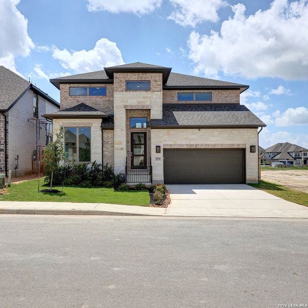 Front exterior of a new home in Kallison Ranch, San Antonio, TX, highlighting curb appeal (Image 2). Front exterior of a new home in Kallison Ranch, San Antonio, TX, highlighting curb appeal (Image 2).