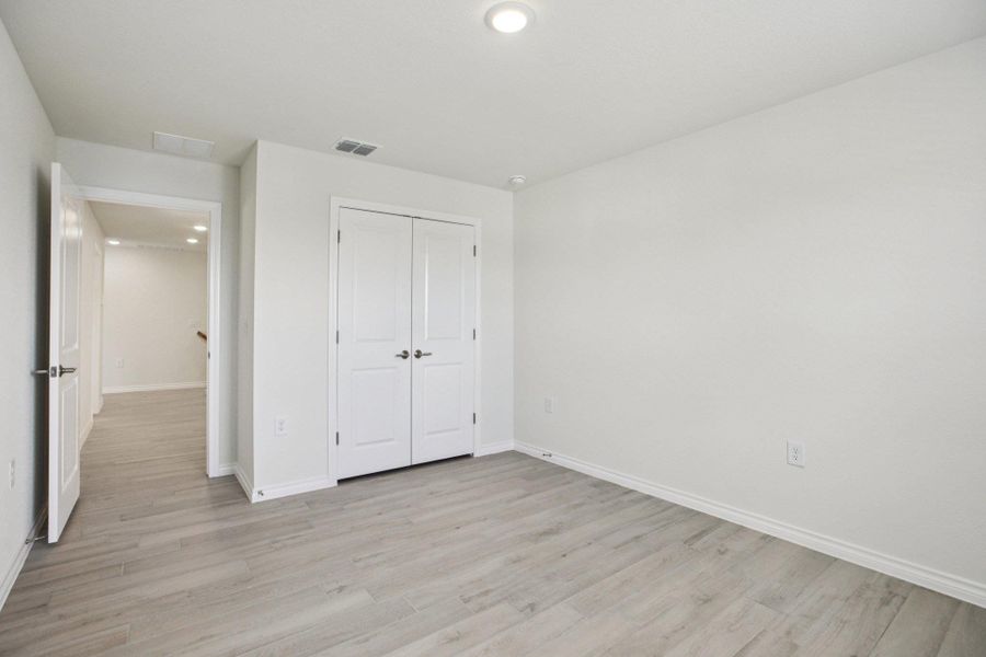 Unfurnished bedroom featuring recessed lighting, light wood finished floors, and a closet