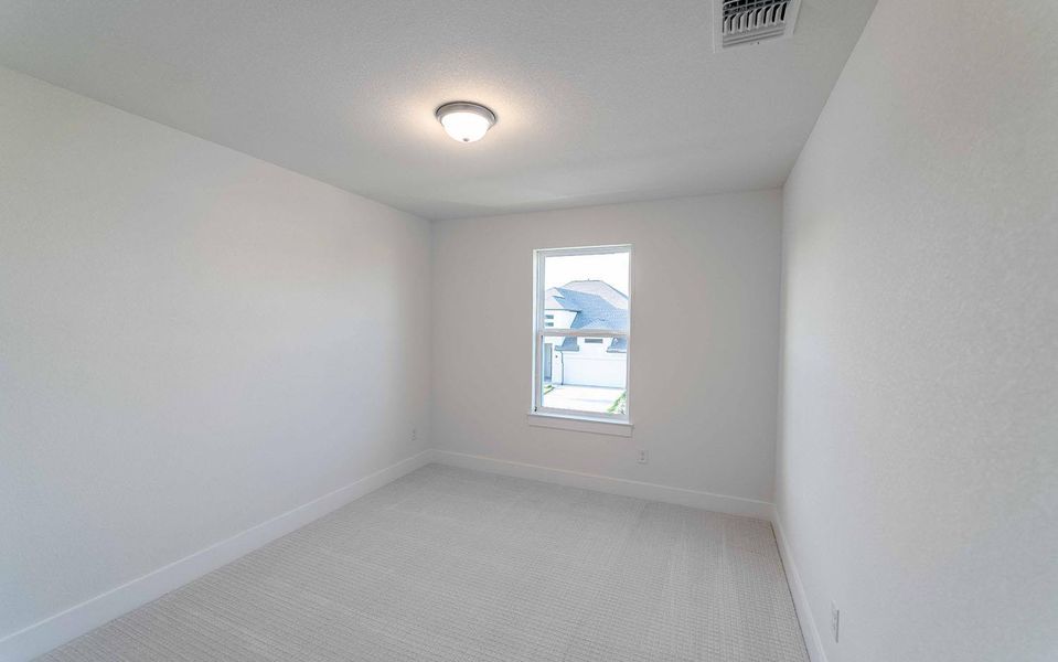 Empty room with baseboards and light colored carpet