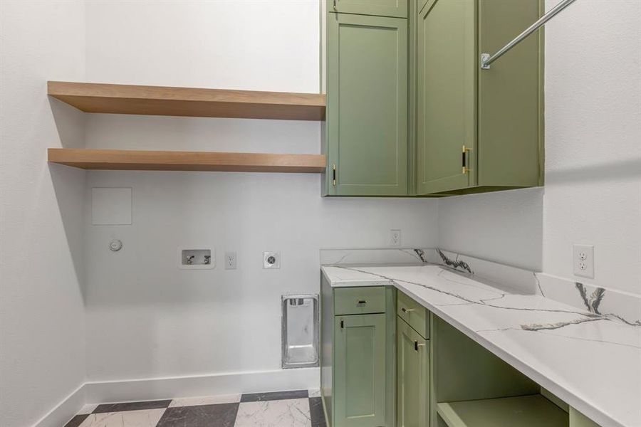 Laundry area with hookup for a washing machine, hookup for an electric dryer, cabinet space, and dark marble finish flooring