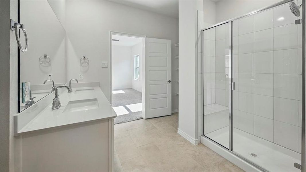 Spacious bathroom featuring a dual vanity with a white countertop, two undermount sinks, and polished chrome faucets Spacious bathroom featuring a dual vanity with a white countertop, two undermount sinks, and polished chrome faucets