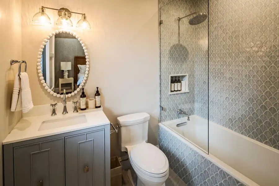 39 - Bathroom with gray vanity, oval mir