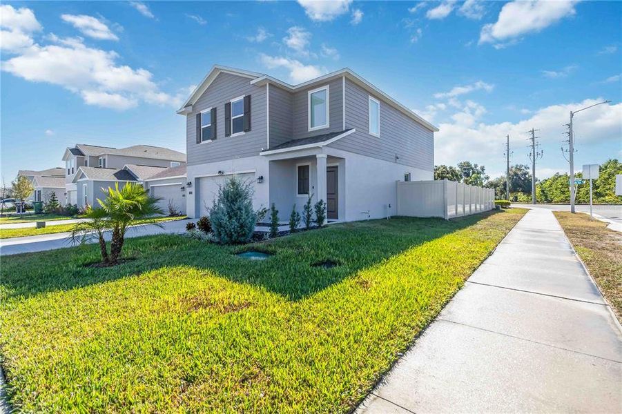 Front exterior of a new home in Peace Creek Reserve: Manor Key Collection, Winter Haven, FL, highlighting curb appeal (Image 30).
