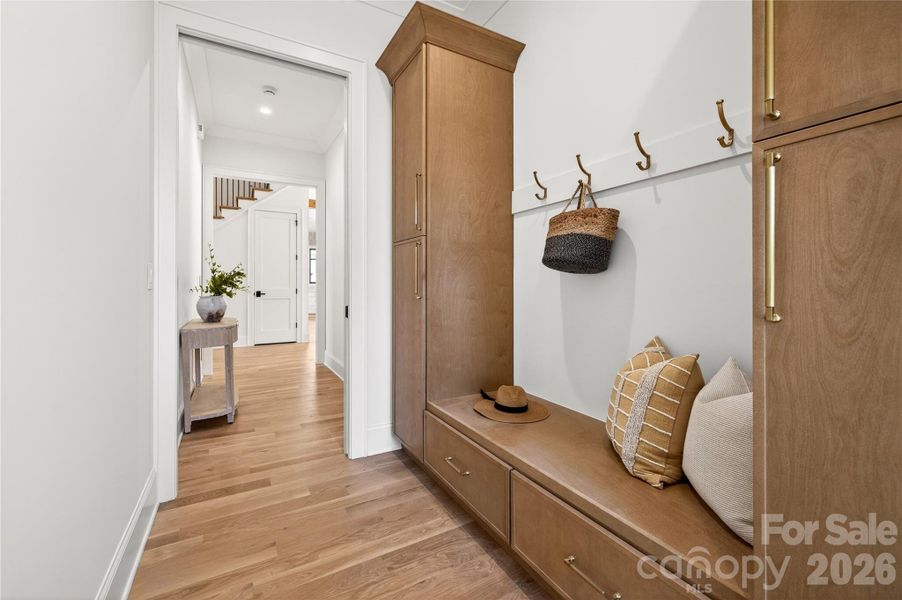 Drop Zone from the 2-car Garage. Beautiful built-in cabinet for coats, boots, athletic equipment and more! Connects to the side hallway off the Entry Hall.