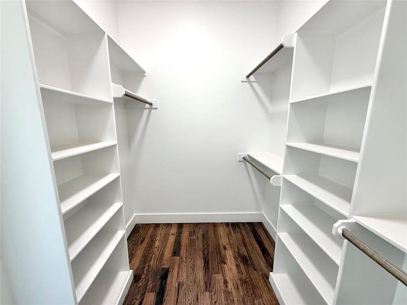 Spacious closet featuring dark wood-type flooring Spacious closet featuring dark wood-type flooring