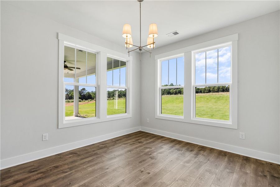 Hardwood floors and generous windows frame verdant