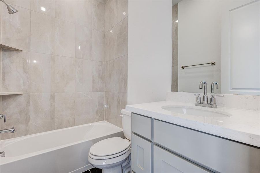 Full bathroom with shower / bath combination, vanity, and toilet